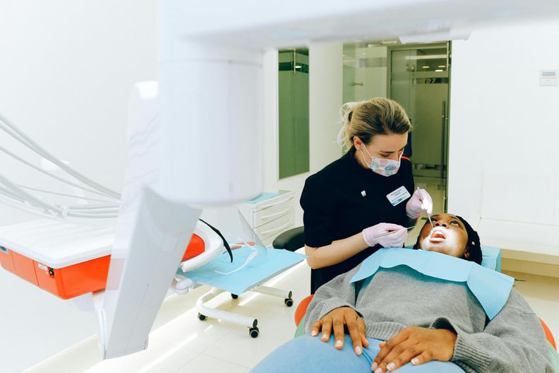 Dentist assisiting Patient