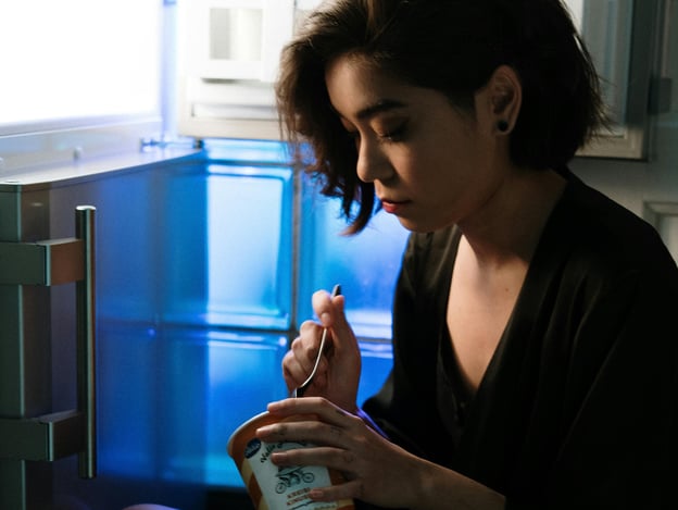 Person eating ice cream as a late night snack