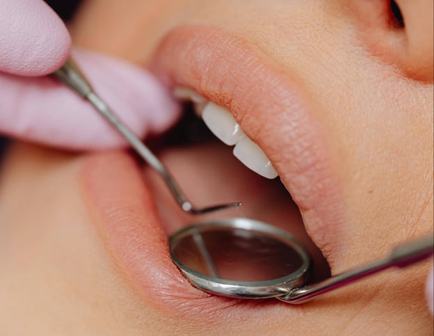 Dental tools near a mouth