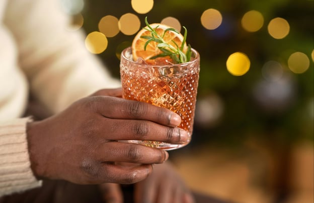 Person holding a holiday cocktail