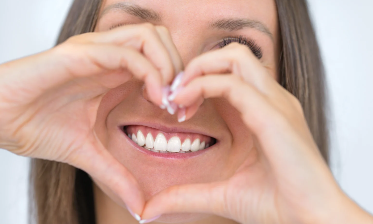 Heart hands around smile