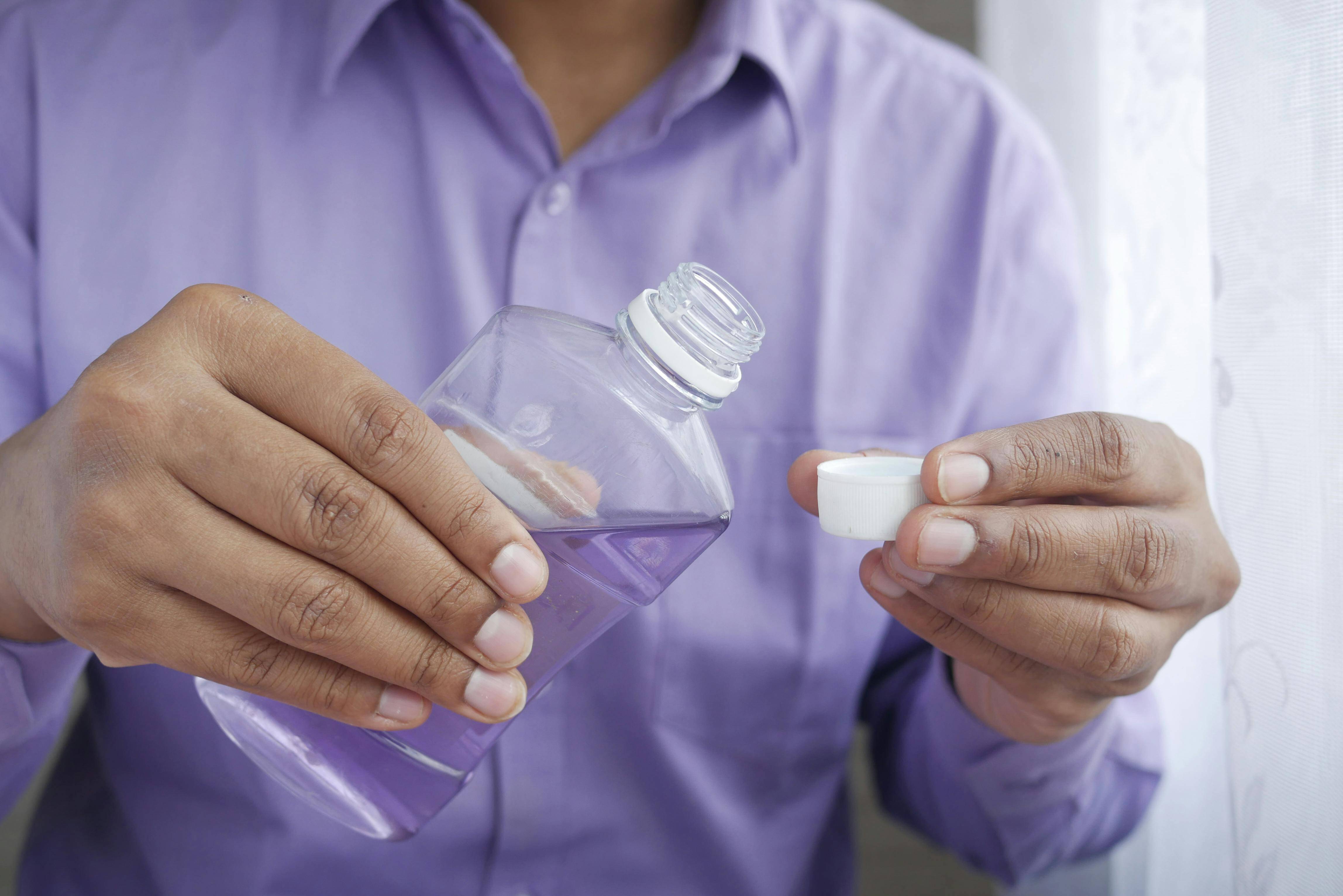 Person using mouthwash